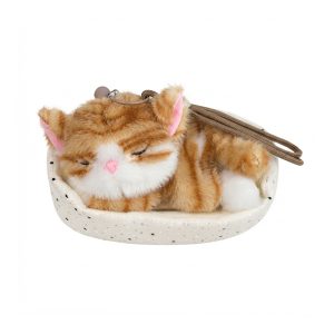 Plush orange and white tabby cat sleeping peacefully on a small cushioned mat